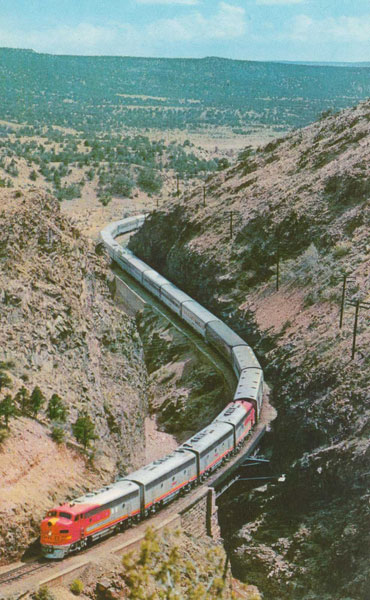 Postcard of a Santa Fe train going through Apache Canyon near Lamy (credit Fred Harvey 7C-K2876, C-5903). Postcard of a Santa Fe train going through Apache Canyon near Lamy (credit Fred Harvey 7C-K2876, C-5903).