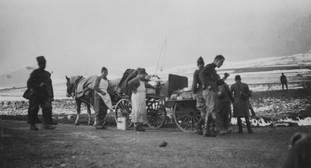 Swiss Army personnel gathered around a horse-drawn mobile field kitchen / supply wagon. Swiss Army personnel gathered around a horse-drawn mobile field kitchen / supply wagon in the snow.
