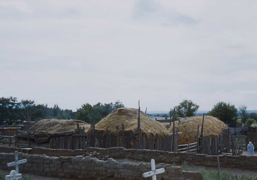 Taos Indian village - haystacks and a Christian cemetery (photo by Henry Tribe 1958). Taos Indian village - haystacks and a Christian cemetery (photo by Henry Tribe 1958).